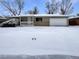 Ranch-style home with a snow-covered front yard and attached garage at 3569 W 89Th Ave, Westminster, CO 80031