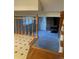 Basement with a cozy brick fireplace and carpeting, seen from the top of stairs at 2995 S Whiting Way, Denver, CO 80231