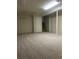 Large basement featuring a carpeted floor, white walls, and a staircase at 2995 S Whiting Way, Denver, CO 80231