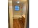 Neutral bathroom featuring a shower-tub combo, window, and vanity at 2995 S Whiting Way, Denver, CO 80231