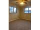 Comfortable bedroom featuring wall-to-wall carpeting, a ceiling fan, and windows providing natural light at 2995 S Whiting Way, Denver, CO 80231