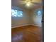 Bright bedroom featuring hardwood floors, neutral walls, and updated ceiling fan at 2995 S Whiting Way, Denver, CO 80231
