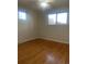 Bedroom with hardwood floors, two windows, and neutral paint, creating a serene and inviting atmosphere at 2995 S Whiting Way, Denver, CO 80231