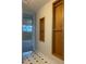 Hallway with tiled floor and built-in wooden shelves at 2995 S Whiting Way, Denver, CO 80231