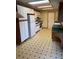 Functional kitchen with white cabinetry, tiled flooring, and ample counter space for meal preparation at 2995 S Whiting Way, Denver, CO 80231