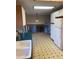 Functional kitchen with tiled flooring, white appliances, and a view of the staircase leading to the upper level at 2995 S Whiting Way, Denver, CO 80231