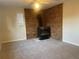 Spacious living room featuring brick fireplace and large window at 2995 S Whiting Way, Denver, CO 80231