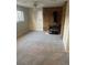 Large carpeted living room featuring a brick fireplace and multiple windows at 2995 S Whiting Way, Denver, CO 80231