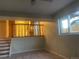 Cozy carpeted living room with window and view into the updated kitchen at 2995 S Whiting Way, Denver, CO 80231