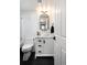 Stylish bathroom with white subway tiles, a marble vanity, and black hexagonal floor tiles at 1415 E 16Th Ave # 1/2, Denver, CO 80218