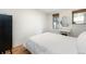 Simple bedroom with white bedding and a black dresser at 1415 E 16Th Ave # 1/2, Denver, CO 80218