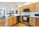 Modern kitchen with stainless steel appliances and light wood cabinets at 1415 E 16Th Ave # 1/2, Denver, CO 80218