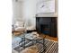 Elegant living room with a fireplace and contemporary glass coffee tables at 1415 E 16Th Ave # 1/2, Denver, CO 80218