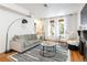Spacious living room with hardwood floors and large windows at 1415 E 16Th Ave # 1/2, Denver, CO 80218