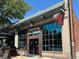 Exterior of Dos Santos restaurant, brick building with large windows at 1415 E 16Th Ave # 1/2, Denver, CO 80218