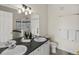 Bathroom featuring double sinks, generous vanity space and a glass-enclosed walk-in shower at 12335 E 2Nd Dr, Aurora, CO 80011
