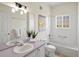 Bathroom featuring double sinks, generous vanity space and a tiled shower-over-tub at 12335 E 2Nd Dr, Aurora, CO 80011