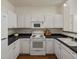 Efficient kitchen featuring white appliances and ample cabinet space at 12335 E 2Nd Dr, Aurora, CO 80011
