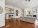 Open-concept layout with hardwood floors, fireplace, and adjacent kitchen area at 12335 E 2Nd Dr, Aurora, CO 80011