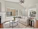Bright living room with large windows, vaulted ceiling, and hardwood floors at 12335 E 2Nd Dr, Aurora, CO 80011