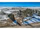 Aerial view of beautiful home and snow covered farm, with distant mountain views at 6597 S State Highway 83, Franktown, CO 80116