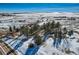 Aerial view of property with snow, trees and road at 6597 S State Highway 83, Franktown, CO 80116