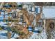 Aerial shot of a property with multiple buildings, snow patches, and a network of driveways at 6597 S State Highway 83, Franktown, CO 80116