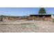 Property featuring metal corrals and wooden fencing on grassy acreage with mountainous background at 6597 S State Highway 83, Franktown, CO 80116