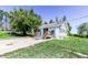 Home's exterior with new gray porch and wood railing. Features include a concrete driveway and green lawn at 6597 S State Highway 83, Franktown, CO 80116