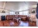 Inviting living room with a plush sectional, wood floors, and ample natural light from large windows at 6597 S State Highway 83, Franktown, CO 80116