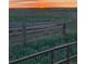 Fenced horse property at sunset, highlighting the tranquility and security of this serene rural environment at 6597 S State Highway 83, Franktown, CO 80116