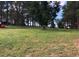 Spacious yard with mature trees, including a picnic table and ride-on mower at 6597 S State Highway 83, Franktown, CO 80116