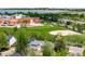 Aerial view of a school with a playground, sports field and a lake, surrounded by lovely homes at 5674 S Ingalls St, Littleton, CO 80123