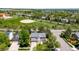An aerial view of the home with a lush green landscape and baseball field in the background at 5674 S Ingalls St, Littleton, CO 80123