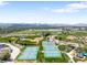 Stunning aerial view showcasing numerous tennis courts surrounded by lush greenery, athletic fields, and mountain views at 5674 S Ingalls St, Littleton, CO 80123