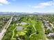 Breathtaking aerial view of a golf course with ponds, surrounded by picturesque landscapes and majestic mountains at 5674 S Ingalls St, Littleton, CO 80123