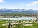 Scenic aerial view of park featuring playground, lake, and mountain views perfect for families and outdoor enjoyment at 5674 S Ingalls St, Littleton, CO 80123