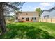 Expansive backyard with lush green grass, a wooden deck, and a two-story home at 5674 S Ingalls St, Littleton, CO 80123