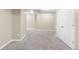 Spacious basement area with neutral carpet and paint, offering a flexible living space at 5674 S Ingalls St, Littleton, CO 80123