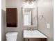 Cozy bathroom showcasing rustic wood finishes, stylish mirror and modern sink at 5674 S Ingalls St, Littleton, CO 80123