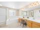 Well-lit bathroom featuring a soaking tub, double vanity, and a separate shower at 5674 S Ingalls St, Littleton, CO 80123