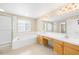Bathroom with a large tub, separate shower, double sink vanity, and ample counter space at 5674 S Ingalls St, Littleton, CO 80123