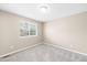 Empty bedroom features neutral colors, one window, and soft carpet at 5674 S Ingalls St, Littleton, CO 80123