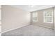 Bright bedroom featuring neutral carpet, and paint with dual windows at 5674 S Ingalls St, Littleton, CO 80123