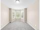 Cozy bedroom features a bay window, neutral paint and carpet at 5674 S Ingalls St, Littleton, CO 80123