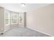 Bedroom featuring a bay window and neutral carpet at 5674 S Ingalls St, Littleton, CO 80123