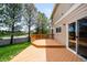 Wooden deck and sliding glass doors offer access to the back of the home and lush green yard at 5674 S Ingalls St, Littleton, CO 80123