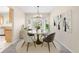 Charming dining room with a round table, elegant chandelier, and bay window view at 5674 S Ingalls St, Littleton, CO 80123