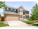 Charming two-story brick home with a well-manicured lawn and a spacious two car garage at 5674 S Ingalls St, Littleton, CO 80123
