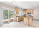 Bright kitchen featuring wood cabinets, stainless appliances, and an island with backyard views at 5674 S Ingalls St, Littleton, CO 80123